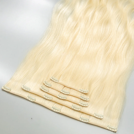A section of light blonde clip-in hair extensions attached to small clips.