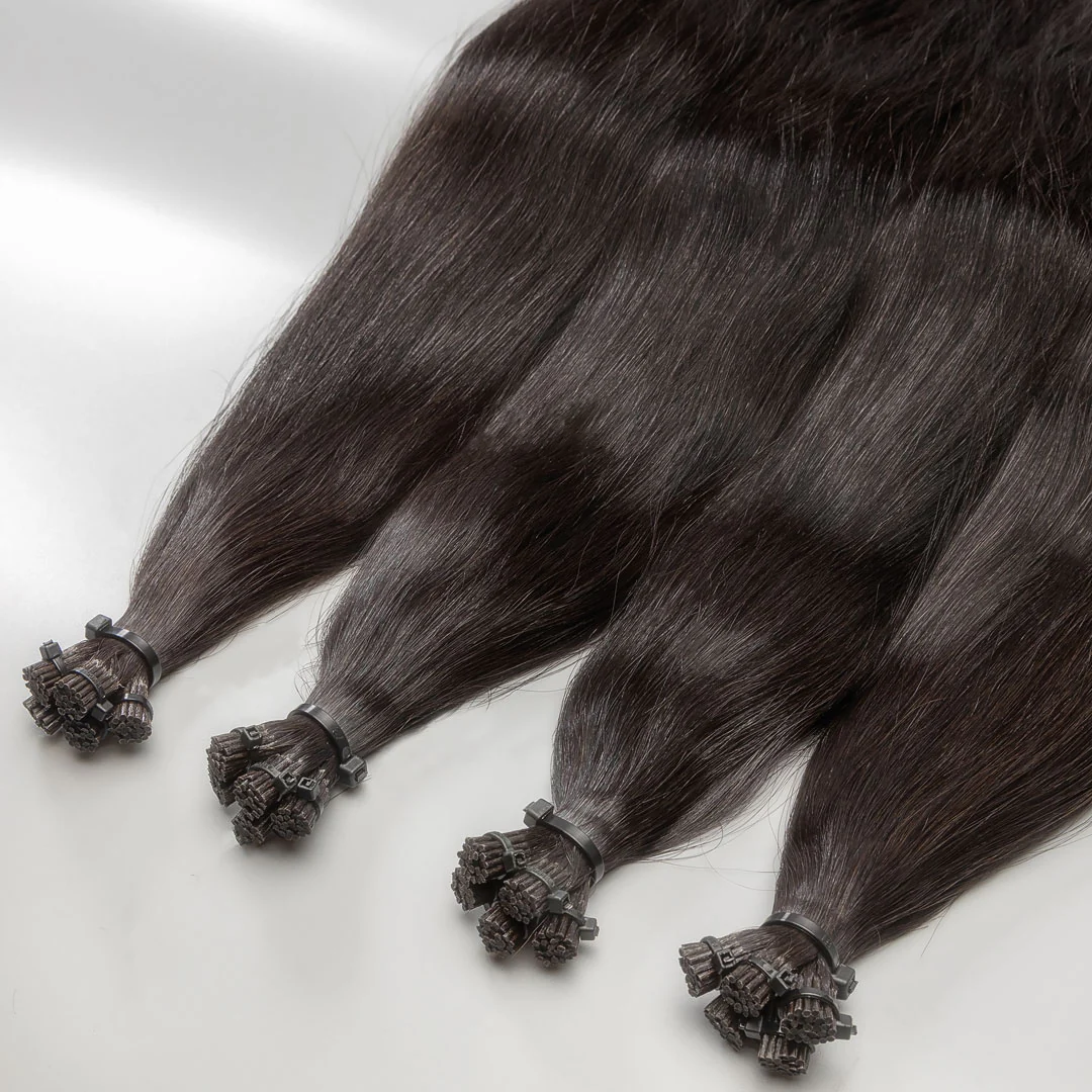 A bundle of darkest brown human hair i-tip extensions with decorative beads.