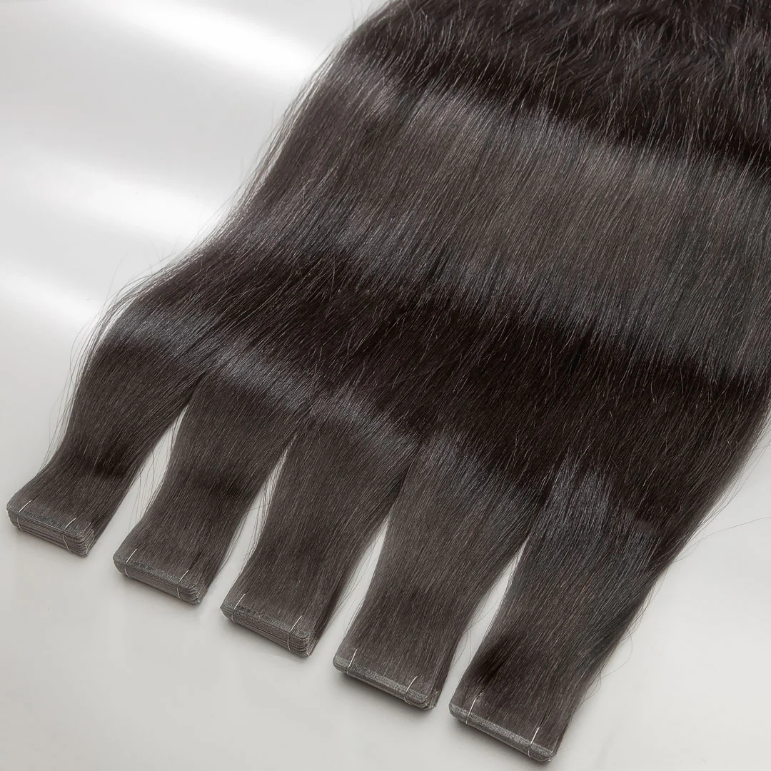A set of dark brown tape-in hair extensions displayed on a white surface.