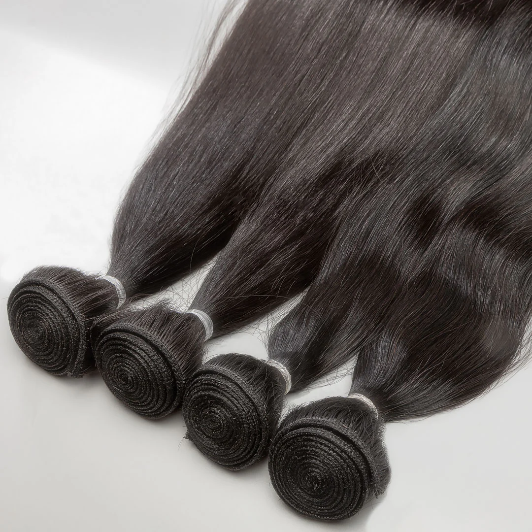 A close-up image of dark brown weft hair extensions tied in bunches.