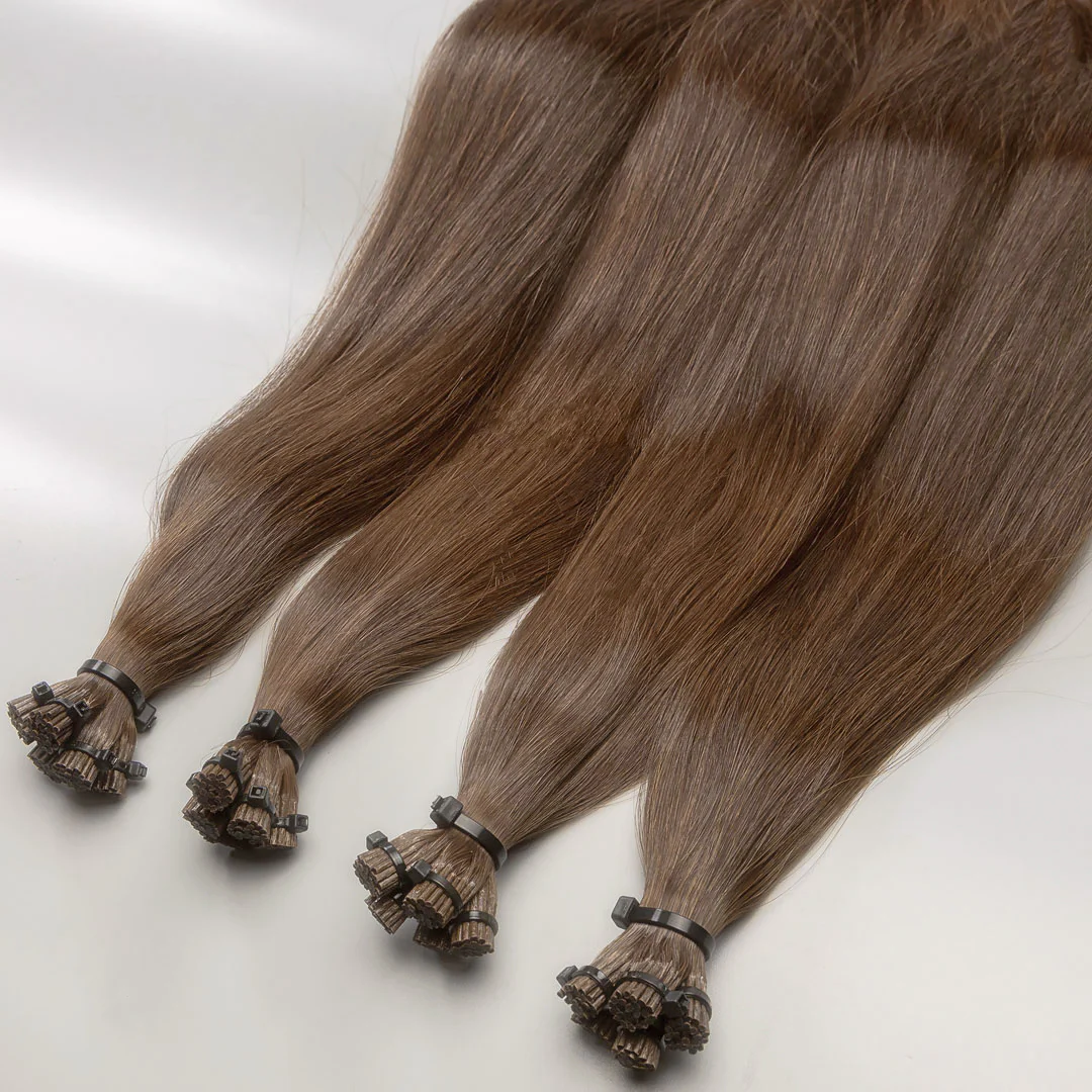 A set of light brown, I-tip hair extensions displayed on a white background.
