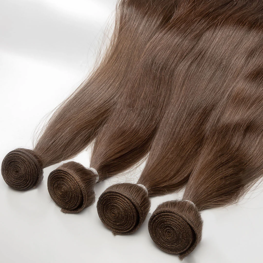 A collection of light brown weft hair extensions displayed on a white background.