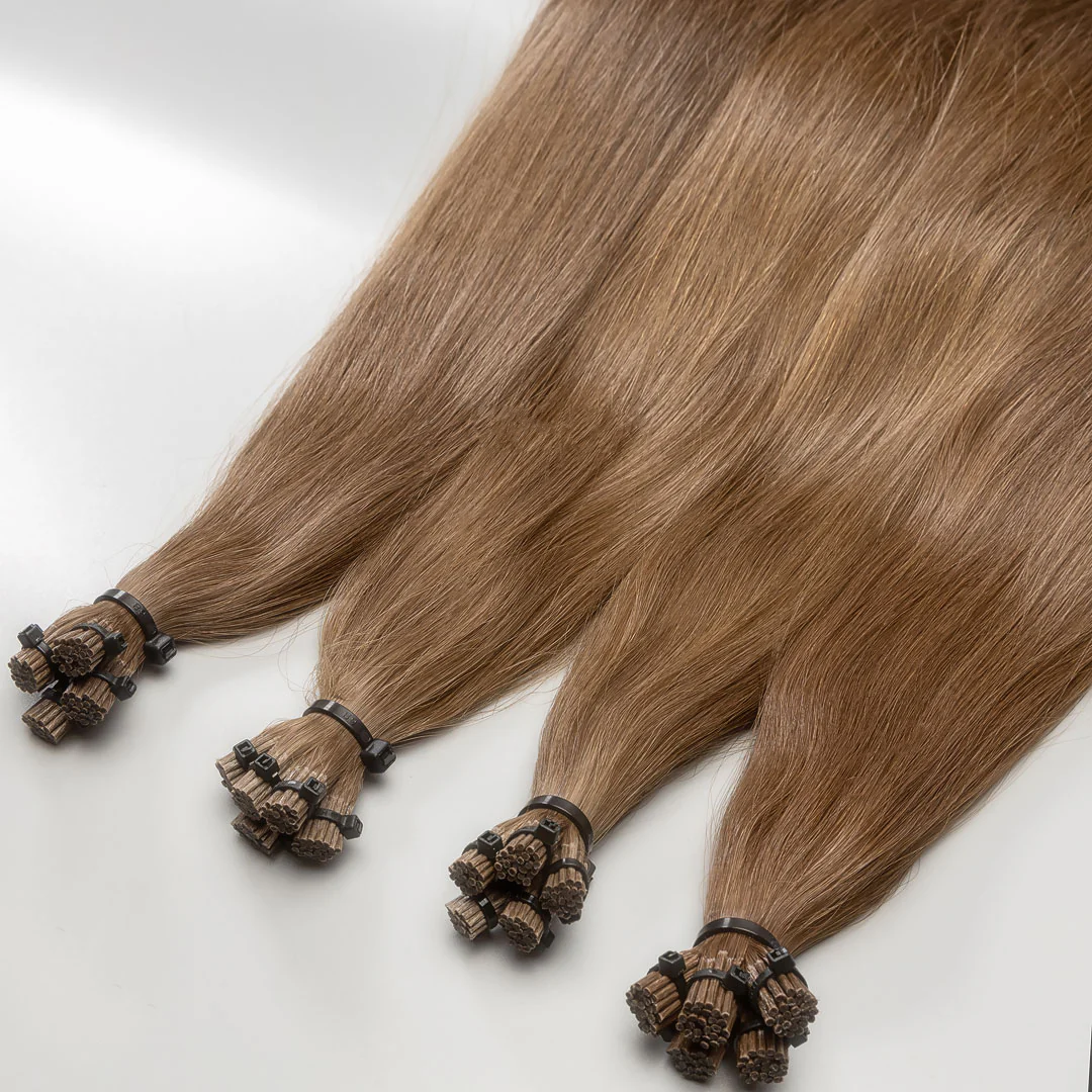 A photo of I-tip hair extension strands with a lightest brown color, displayed on a white background.