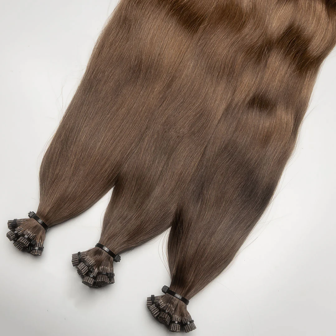 A photo of I-tip hair extension strands with beads, displayed on a white background.