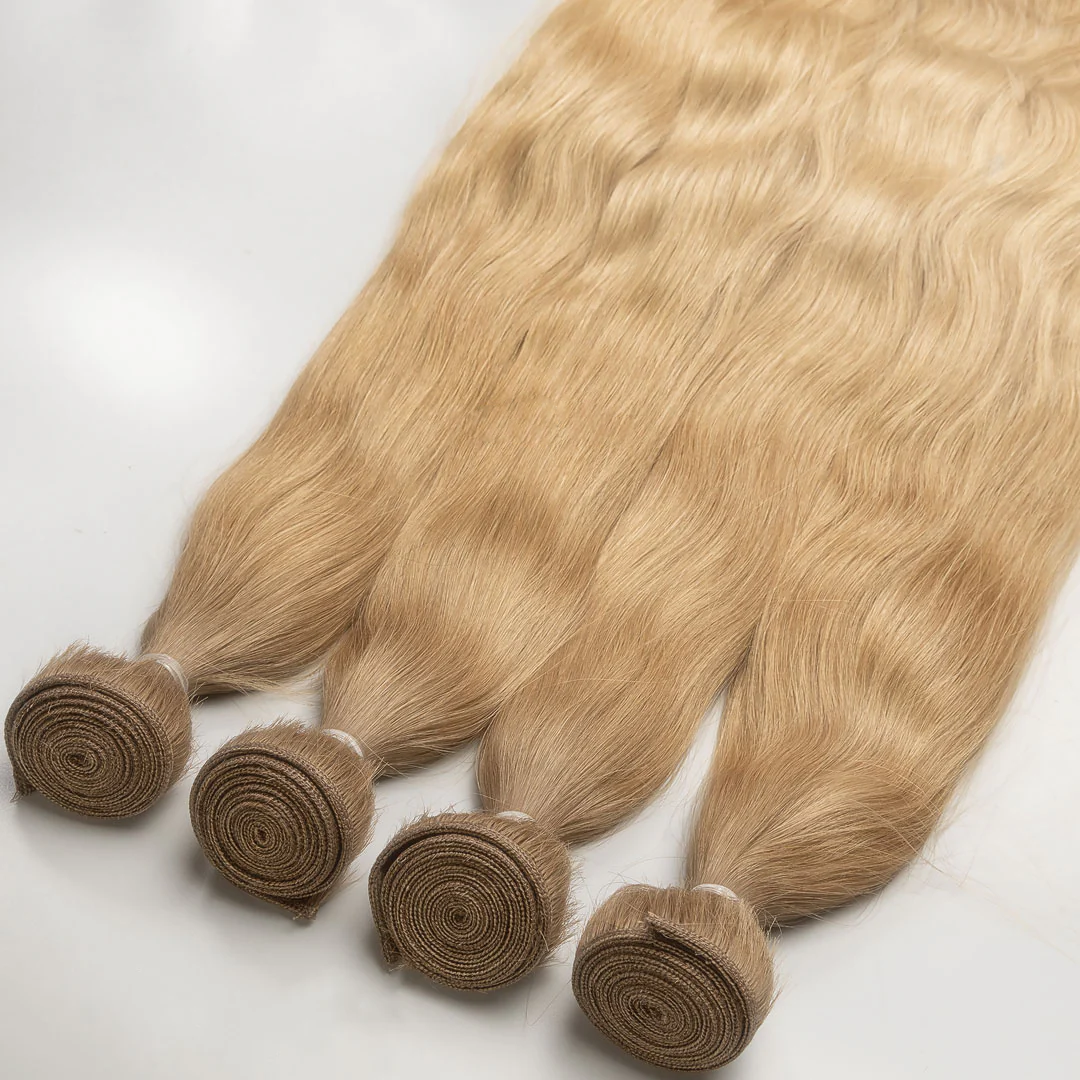 A bundle of golden blonde weft hair extensions tied in a knot.