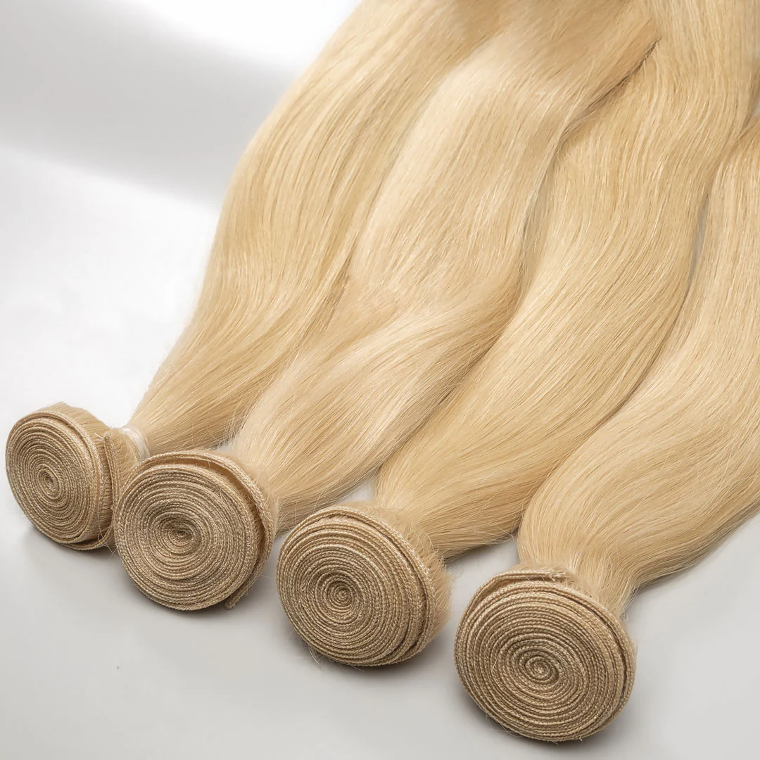 A set of blonde weft hair extensions displayed on a white background.