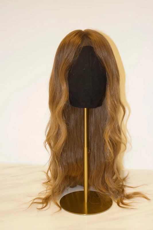 A dark blonde wig displayed on a mannequin head, featuring a natural-looking hairline and long, straight strands.